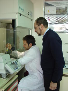 Fernando Simón examina el trabajo de un investigador de su laboratorio